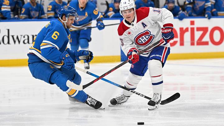 Oct 27, 2026; St. Louis, Missouri, USA;  St. Louis Blues defenseman Philip Broberg (6) and Montreal Canadiens right wing Cole Caufield (13) battle for the puck in the third period at Enterprise Center.  Mandatory Credit: Joe Puetz-Imagn Images