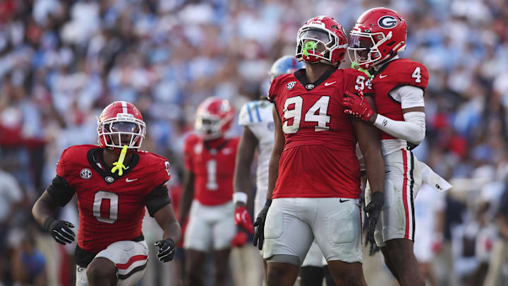 Oct 18, 2025; Athens, Georgia, USA;  Georgia Bulldogs defensive tackle Xzavier McLeod (94) reacts with defensive back Kj Bolden (4) after breaking up a pass against the Mississippi Rebels during the second half of the game at Sanford Stadium. Mandatory Credit: Brett Davis-Imagn Images