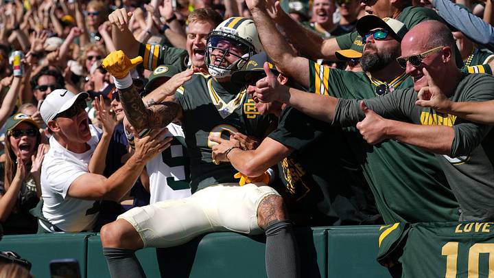 Week 5: Green Bay Packers wide receiver Christian Watson does a Lambeau Leap after scoring a touchdown against the Chicago Bears at Lambeau Field. The Packers defeated the Bears, 31-7.