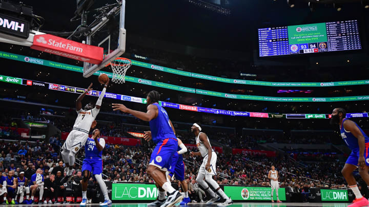 Nov 27, 2023; Los Angeles, California, USA; Denver Nuggets guard Reggie Jackson (7) moves to the basket against Los Angeles Clippers guard Norman Powell (24) during the second half at Crypto.com Arena. Mandatory Credit: Gary A. Vasquez-USA TODAY Sports