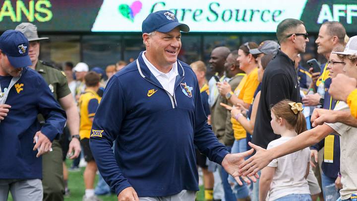 Sep 27, 2025; Morgantown, West Virginia, USA; West Virginia Mountaineers head coach Rich Rodriguez walks on the field and greets fans before their game against the Utah Utes at Milan Puskar Stadium. Mandatory Credit: Ben Queen-Imagn Images Sep 27, 2025; Morgantown, West Virginia, USA; West Virginia Mountaineers head coach Rich Rodriguez walks on the field and greets fans before their game against the Utah Utes at Milan Puskar Stadium. Mandatory Credit: Ben Queen-Imagn Images