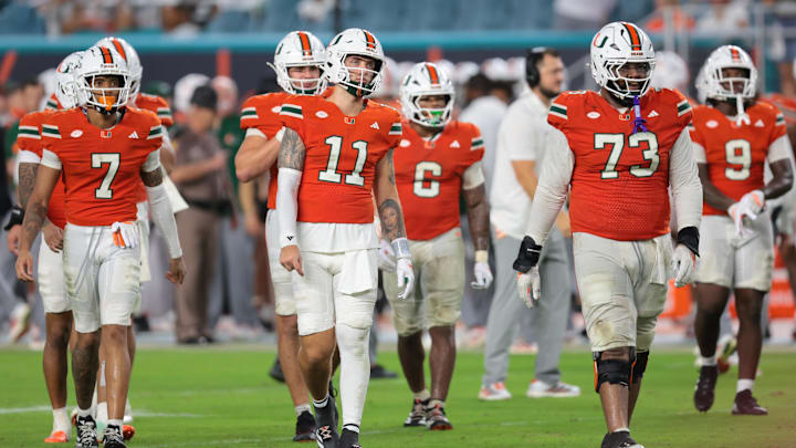 Sep 20, 2025; Miami Gardens, Florida, USA; Miami Hurricanes quarterback Carson Beck (11) and his teammates walk toward the line of scrimmage against the Florida Gators during the fourth quarter at Hard Rock Stadium. Mandatory Credit: Sam Navarro-Imagn Images Sep 20, 2025; Miami Gardens, Florida, USA; Miami Hurricanes quarterback Carson Beck (11) and his teammates walk toward the line of scrimmage against the Florida Gators during the fourth quarter at Hard Rock Stadium. Mandatory Credit: Sam Navarro-Imagn Images