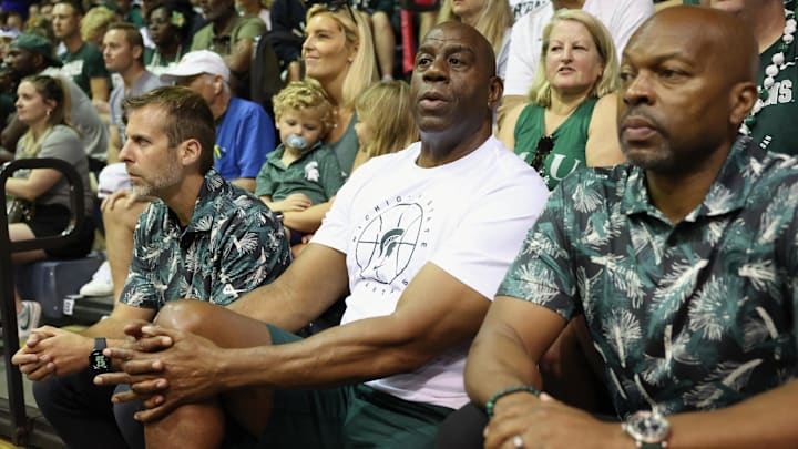 Nov 26, 2024; Lahaina, Hawaii, USA;  Former professional basketball player and Michigan State alumni, Earvin “Magic” Johnson (center) watches the Michigan State Spartans take on the Memphis Tigers in the second half at Lahaina Civic Center. Mandatory Credit: Marco Garcia-Imagn Images
