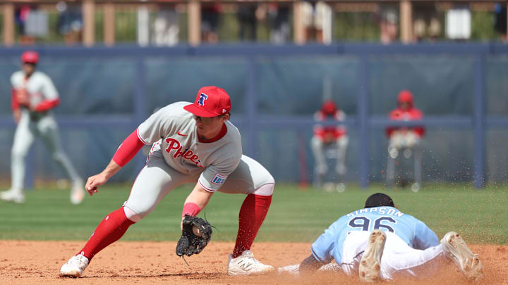 Feb 25, 2025; Port Charlotte, Florida, USA;  Tampa Bay Rays outfielder Chandler Simpson (96) slides safely into second base against Philadelphia Phillies infielder Aidan Miller (81) at Charlotte Sports Park. Mandatory Credit: Kim Klement Neitzel-Imagn Images