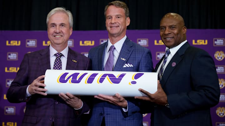 Dec 1, 2025; Baton Rouge, LA, USA; LSU president Wade Rousse, left, LSU new head coach Lane Kiffin and LSU athletic director Verge Ausberry stand together at South Stadium Club at Tiger Stadium. Mandatory Credit: Matthew Hinton-Imagn Images Dec 1, 2025; Baton Rouge, LA, USA; LSU president Wade Rousse, left, LSU new head coach Lane Kiffin and LSU athletic director Verge Ausberry stand together at South Stadium Club at Tiger Stadium. Mandatory Credit: Matthew Hinton-Imagn Images