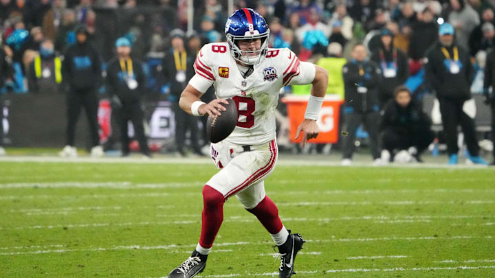 Nov 10, 2024; Munich, Germany; New York Giants quarterback Daniel Jones (8) carries the ball against the New York Giants in the second half during the 2024 NFL Munich Game at Allianz Arena. 