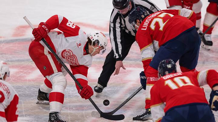 Apr 15, 2026; Sunrise, Florida, USA; Detroit Red Wings center Emmitt Finnie (58) and Florida Panthers center Eetu Luostarinen (27) face off during the third period at Amerant Bank Arena. Mandatory Credit: Sam Navarro-Imagn Images