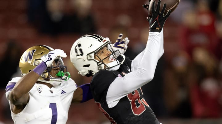 Oct 28, 2023; Stanford, California, USA; Stanford Cardinal wide receiver Jackson Harris (83) hauls in a 43-yard pass in front of Washington Huskies cornerback Jabbar Muhammad (1) during the fourth quarter at Stanford Stadium. Mandatory Credit: D. Ross Cameron-USA TODAY Sports