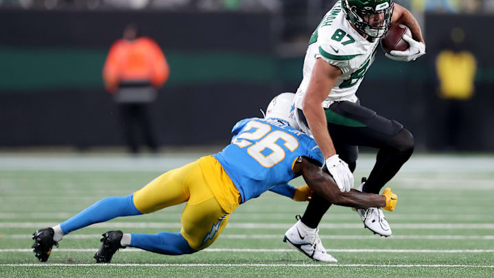 Nov 6, 2023; East Rutherford, New Jersey, USA; New York Jets tight end C.J. Uzomah (87) runs with the ball against Los Angeles Chargers cornerback Asante Samuel Jr. (26) during the third quarter at MetLife Stadium. Mandatory Credit: Brad Penner-Imagn Images