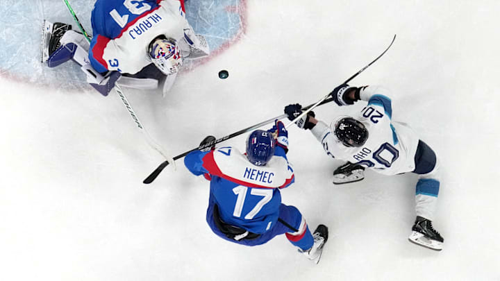 [US, Mexico & Canada customers only] Feb 11, 2026; Milan, Italy; Samuel Hlavaj and Simon Nemec of Slovakia in action with Sebastian Aho of Finland  in men's ice hockey group B play during the Milano Cortina 2026 Olympic Winter Games at Milano Santagiulia Ice Hockey Arena. Mandatory Credit: David W Cerny/Reuters via Imagn Images