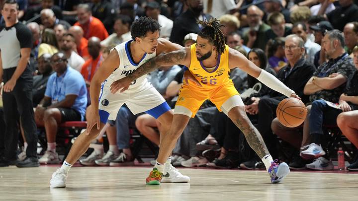 Jul 10, 2025; Las Vegas, NV, USA; Los Angeles Lakers guard RJ Davis (26) dribbles against Dallas Mavericks guard Ryan Nembhard (9) in the first quarter of their game at Thomas & Mack Center. Mandatory Credit: Candice Ward-Imagn Images Jul 10, 2025; Las Vegas, NV, USA; Los Angeles Lakers guard RJ Davis (26) dribbles against Dallas Mavericks guard Ryan Nembhard (9) in the first quarter of their game at Thomas & Mack Center. Mandatory Credit: Candice Ward-Imagn Images
