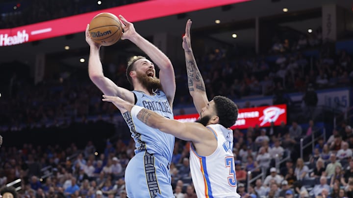 Mar 27, 2025; Oklahoma City, Oklahoma, USA; Memphis Grizzlies center Jay Huff (30) goes to the basket against Oklahoma City Thunder forward Kenrich Williams (34) during the second half at Paycom Center. Mandatory Credit: Alonzo Adams-Imagn Images