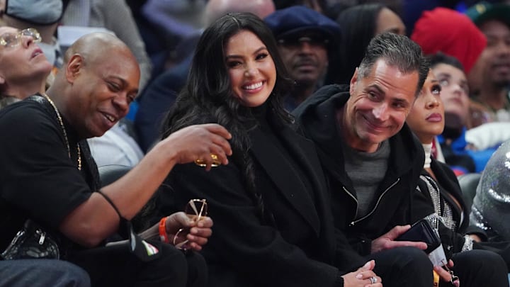 Vanessa Bryant sits between Dave Chapelle (left) and Lakers general manager Rob Pelinka (right) during the 2022 NBA All-Star Game at Rocket Mortgage FieldHouse. Vanessa Bryant sits between Dave Chapelle (left) and Lakers general manager Rob Pelinka (right) during the 2022 NBA All-Star Game at Rocket Mortgage FieldHouse.