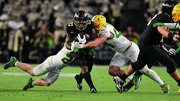 Oct 18, 2024; West Lafayette, Indiana, USA; Purdue Boilermakers running back Reggie Love III (23) is tackled by Oregon Ducks linebacker Teitum Tuioti (44) during the second half at Ross-Ade Stadium.