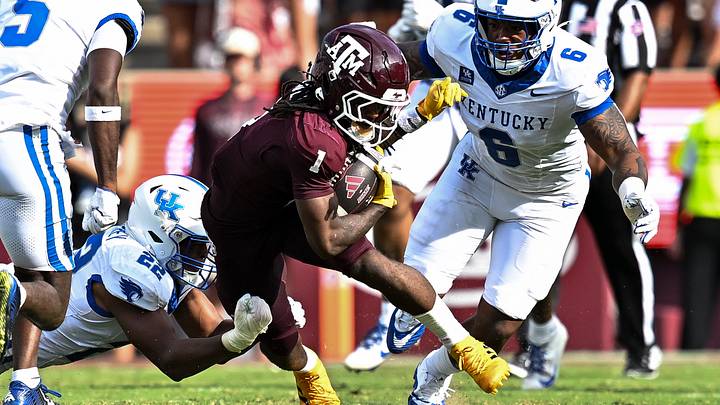 Texas A&M wide receiver Mario Craver stumbles as he runs the ball against Kentucky linebacker Grant Godfrey (bottom) and defensive tackle Ahmad Breaux (6). Texas A&M wide receiver Mario Craver stumbles as he runs the ball against Kentucky linebacker Grant Godfrey (bottom) and defensive tackle Ahmad Breaux (6).