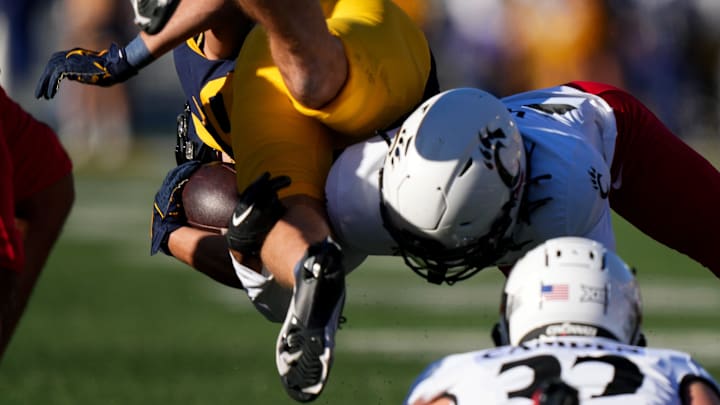 Cincinnati Bearcats safety Ken Willis (27) tackles West Virginia Mountaineers wide receiver Preston Fox (29) on the opening kickoff in the first quarter during an NCAA college football game between the Cincinnati Bearcats and the West Virginia Mountaineers, Saturday, Nov. 18, 2023, at Milan Puskar Stadium in Morgantown, W. Va. Cincinnati Bearcats safety Ken Willis (27) tackles West Virginia Mountaineers wide receiver Preston Fox (29) on the opening kickoff in the first quarter during an NCAA college football game between the Cincinnati Bearcats and the West Virginia Mountaineers, Saturday, Nov. 18, 2023, at Milan Puskar Stadium in Morgantown, W. Va.