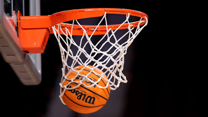 A detail shot of a basketball going through the hoop A detail shot of a basketball going through the hoop