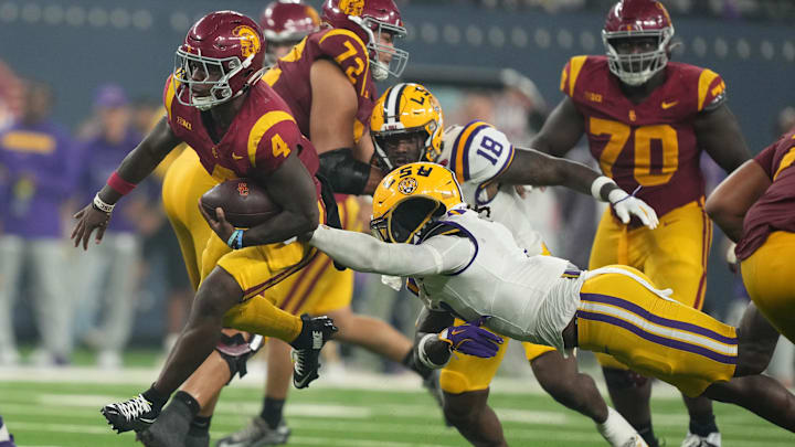 Sep 1, 2024; Paradise, Nevada, USA; Southern California Trojans running back Woody Marks (4) carries the ball against LSU Tigers linebacker Harold Perkins Jr. (7) in the second half at Allegiant Stadium. Mandatory Credit: Kirby Lee-Imagn Images