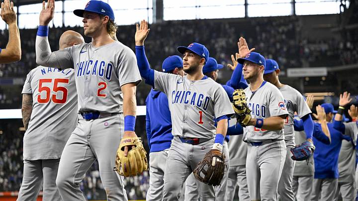 Mar 31, 2024; Arlington, Texas, USA; Chicago Cubs second baseman Nico Hoerner (2) and third baseman Nick Madrigal (1) and third baseman Miles Mastrobuoni (20) celebrates after the Cubs defeat the Texas Rangers at Globe Life Field. Mandatory Credit: Jerome Miron-Imagn Images