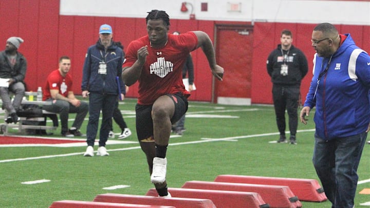 Former Wisconsin nose tackle Keeanu Benton goes through drills as an NFL scouts looks on during the Badgers pro day at the McClain Center in Madison, Wis. on Thursday March 22, 2023 Former Wisconsin nose tackle Keeanu Benton goes through drills as an NFL scouts looks on during the Badgers pro day at the McClain Center in Madison, Wis. on Thursday March 22, 2023