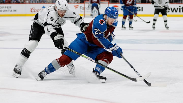 Jan 26, 2024; Denver, Colorado, USA; Colorado Avalanche right wing Logan O'Connor (25) controls the puck ahead of Los Angeles Kings right wing Adrian Kempe (9) in the second period at Ball Arena. Mandatory Credit: Isaiah J. Downing-Imagn Images