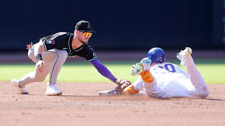 Jun 1, 2024; New York City, New York, USA; New York Mets first baseman Pete Alonso (20) slides into second base for a double ahead of the tag by Arizona Diamondbacks second baseman Blaze Alexander (9) during the first inning at Citi Field. Mandatory Credit: Brad Penner-Imagn Images