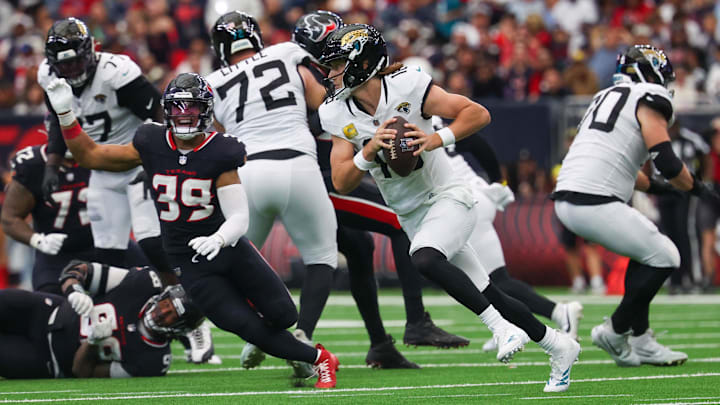 Nov 9, 2025; Houston, Texas, USA;Jacksonville Jaguars quarterback Trevor Lawrence (16) scrambles against the Houston Texans in the second half at NRG Stadium. Mandatory Credit: Thomas Shea-Imagn Images