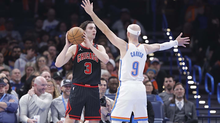 Mar 31, 2025; Oklahoma City, Oklahoma, USA; Chicago Bulls guard Josh Giddey (3) looks to pass as Oklahoma City Thunder guard Alex Caruso (9) defends during the second quarter at Paycom Center. Mandatory Credit: Alonzo Adams-Imagn Images