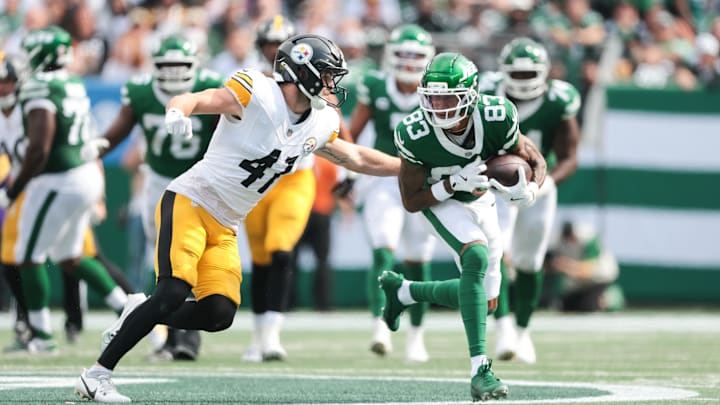 Sep 7, 2025; East Rutherford, New Jersey, USA; New York Jets wide receiver Josh Reynolds (83) fights for yards against Pittsburgh Steelers linebacker Payton Wilson (41) during the fourth quarter at MetLife Stadium. Mandatory Credit: Vincent Carchietta-Imagn Images