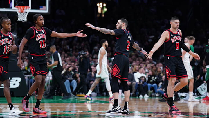 Dec 19, 2024; Boston, Massachusetts, USA; Chicago Bulls guard Lonzo Ball (2), center Nikola Vucevic (9) and forward Julian Phillips (15) react during a break in the action against the Boston Celtics in the second quarter at TD Garden. Mandatory Credit: David Butler II-Imagn Images