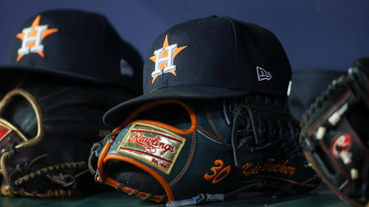 Apr 21, 2023; Atlanta, Georgia, USA; A detailed view of a Houston Astros hat and glove in the dugout against the Atlanta Braves in the fifth inning at Truist Park. Mandatory Credit: Brett Davis-Imagn Images