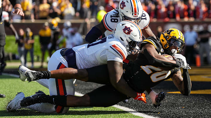 Oct 19, 2024; Columbia, Missouri, USA; Missouri Tigers running back Jamal Roberts (20) scores a touchdown against Auburn Tigers cornerback Mac McClinton (27) and safety Kaleb Harris (18) during the second half at Faurot Field at Memorial Stadium. Mandatory Credit: Jay Biggerstaff-Imagn Images