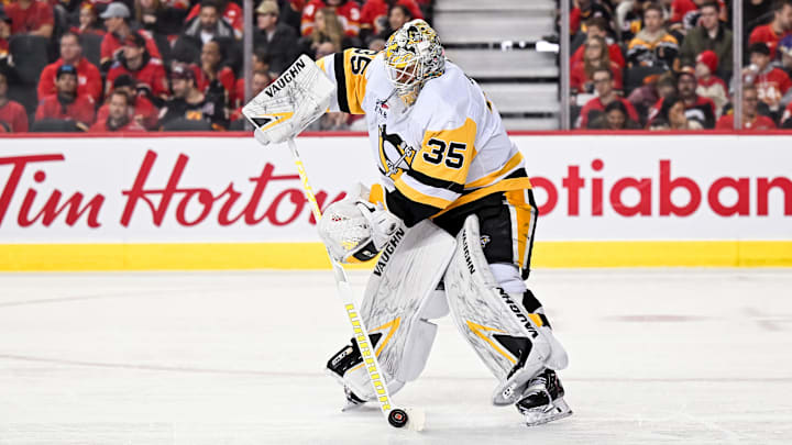 Mar 2, 2024; Calgary, Alberta, CAN; Pittsburgh Penguins goaltender Tristan Jarry (35) handles the puck during the first period in a game against the Calgary Flames at Scotiabank Saddledome. Mandatory Credit: Brett Holmes-Imagn Images