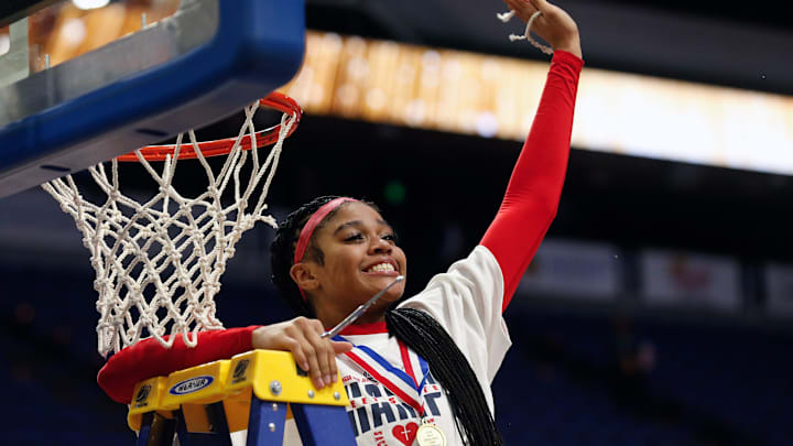 Sacred Heart's Zakiyah Johnson celebrates her piece of the net after they beat McCracken County in the Mingua Beef Jerky Sweet 16 Girl's Basketball Championship. Mar. 16, 2024