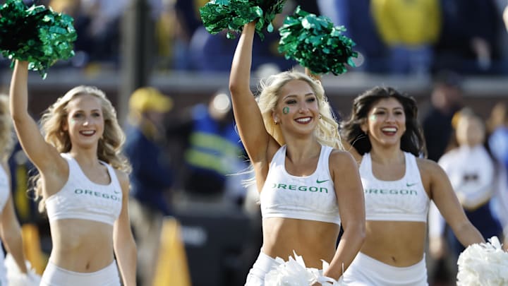 Nov 2, 2024; Ann Arbor, Michigan, USA;  Oregon Ducks cheerleaders celebrate after a score in the first half against the Michigan Wolverines at Michigan Stadium. Mandatory Credit: Rick Osentoski-Imagn Images