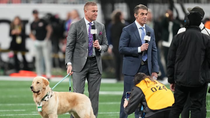 Kirk Herbstreit with his dog Peter before the CFP National Championship college football game between the Notre Dame Fighting Irish and the Ohio State Buckeyes.
