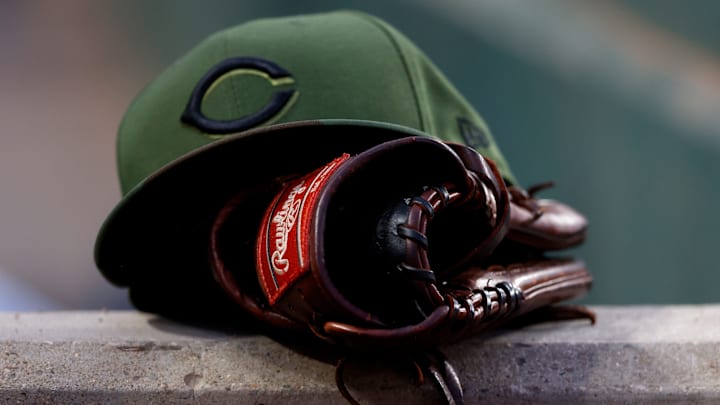 Cincinnati Reds hat sits on the dugout.