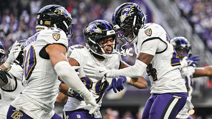 Nov 9, 2025; Minneapolis, Minnesota, USA; Baltimore Ravens safety Keondre Jackson (39) and linebacker Teddye Buchanan (40) and safety Malaki Starks (24) react to a fumble recovery during the third quarter against the Minnesota Vikings at U.S. Bank Stadium. Mandatory Credit: Jeffrey Becker-Imagn Images