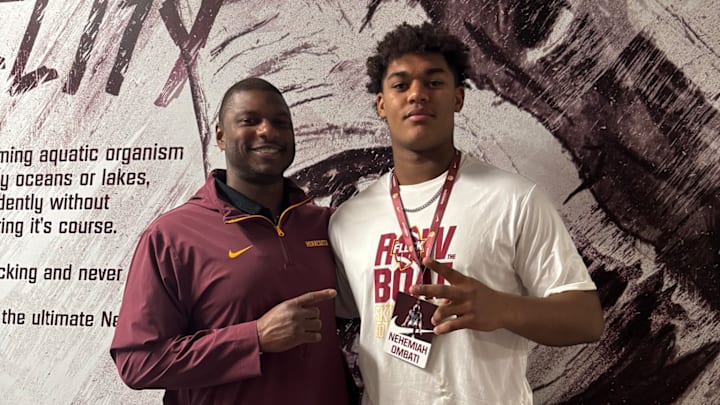 Gophers defensive line coach Dennis Dottin-Carter (left) with Shakopee defensive lineman Nehemiah Ombati (right).