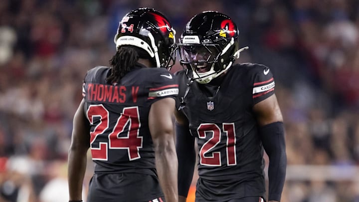 Oct 21, 2024; Glendale, Arizona, USA; Arizona Cardinals cornerback Garrett Williams (21) celebrates play with teammate Starling Thomas V (24) against the Los Angeles Chargers at State Farm Stadium. Mandatory Credit: Mark J. Rebilas-Imagn Images