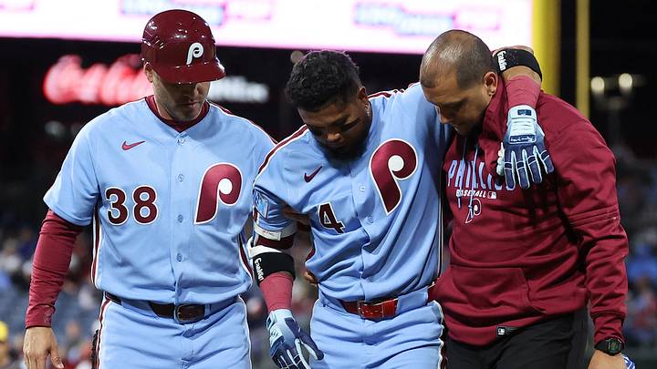 Sep 24, 2026; Philadelphia, Pennsylvania, USA; Philadelphia Phillies second baseman Luis Arraez (4) is helped off the field by trainer Christian Bermudez and first base coach Paco Figueroa (38) after being injured during the sixth inning against the Milwaukee Brewers at Citizens Bank Park. Mandatory Credit: Bill Streicher-Imagn Images
