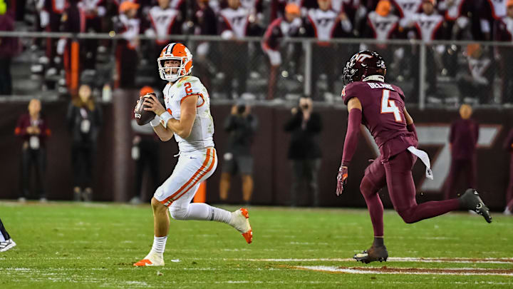 Nov 9, 2024; Blacksburg, Virginia, USA;  Clemson Tigers quarterback Cade Klubnik (2) scrambles looking for a receiver while being pursued by Virginia Tech Hokies cornerback Mansoor Delane (4) during the third quarter at Lane Stadium. Mandatory Credit: Brian Bishop-Imagn Images