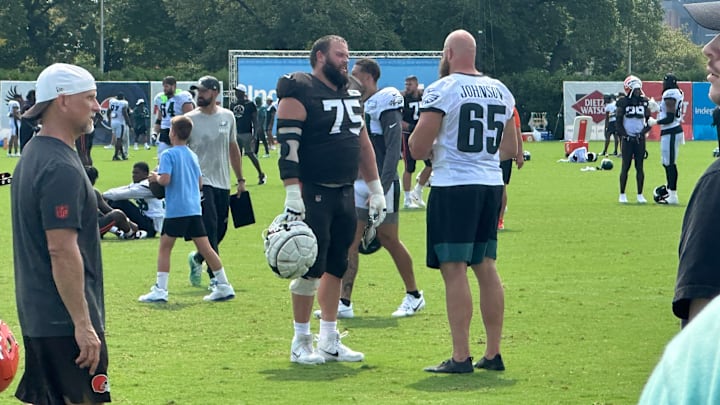 The Browns' Joel Bitonio and the Eagles' Lane Johnson meet up after a joint practice on Aug. 14, 2025.