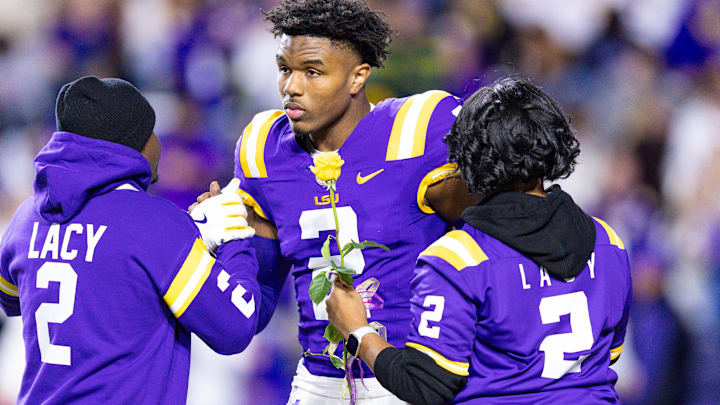 Nov 30, 2024; Baton Rouge, Louisiana, USA; LSU Tigers wide receiver Kyren Lacy (2) hugs his family as seniors are being honored during the beginning of the first quarter at Tiger Stadium. Mandatory Credit: Stephen Lew-Imagn Images Nov 30, 2024; Baton Rouge, Louisiana, USA; LSU Tigers wide receiver Kyren Lacy (2) hugs his family as seniors are being honored during the beginning of the first quarter at Tiger Stadium. Mandatory Credit: Stephen Lew-Imagn Images