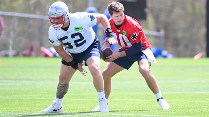 May 11, 2024; Foxborough, MA, USA; New England Patriots quarterback Drake Maye (10) takes a snap from guard/tackle Joey Ramos (52) at the New England Patriots rookie camp at Gillette Stadium.  Mandatory Credit: Eric Canha-USA TODAY Sports