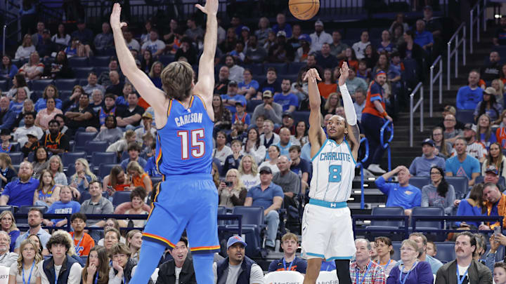 Mar 21, 2025; Oklahoma City, Oklahoma, USA; Charlotte Hornets guard Nick Smith Jr. (8) shoots a three point basket during the second half against the Oklahoma City Thunder at Paycom Center. Mandatory Credit: Alonzo Adams-Imagn Images