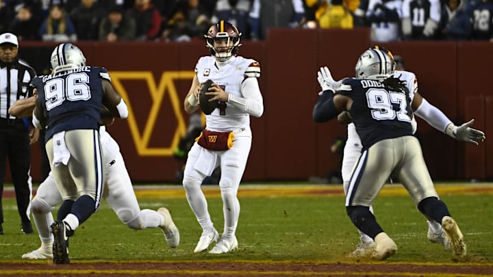 Jan 7, 2024; Landover, Maryland, USA; Washington Commanders quarterback Sam Howell (14) drops back to pass with Neville Gallimore moving in for the sack,