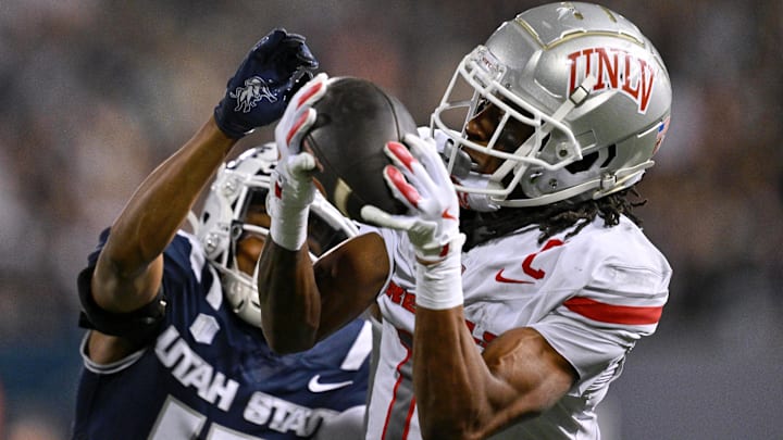 UNLV Rebels wide receiver Ricky White III (11) catches a touchdown pass in front of Utah State Aggies cornerback Avante Dickerson (17) in the first half at Merlin Olsen Field at Maverik Stadium. Mandatory Credit: Jamie Sabau-Imagn Images UNLV Rebels wide receiver Ricky White III (11) catches a touchdown pass in front of Utah State Aggies cornerback Avante Dickerson (17) in the first half at Merlin Olsen Field at Maverik Stadium. Mandatory Credit: Jamie Sabau-Imagn Images