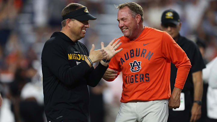Oct 18, 2025; Auburn, Alabama, USA; Missouri Tigers head coach Eli Drinkwitz and Auburn Tigers head coach Hugh Freeze speak before the game at Jordan-Hare Stadium. Mandatory Credit: John Reed-Imagn Images