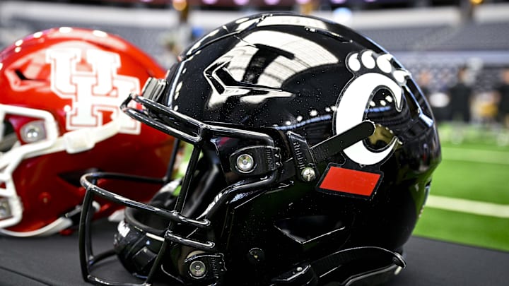 Jul 12, 2023; Arlington, TX, USA; A view of the Cincinnati Bearcats helmet and logo during Big 12 football media day at AT&T Stadium. Mandatory Credit: Jerome Miron-Imagn Images Jul 12, 2023; Arlington, TX, USA; A view of the Cincinnati Bearcats helmet and logo during Big 12 football media day at AT&T Stadium. Mandatory Credit: Jerome Miron-Imagn Images
